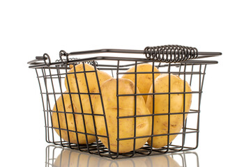 Several raw organic potatoes with a basket, close-up, isolated on a white background.