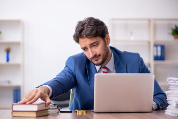 Young male employee and too much work in the office