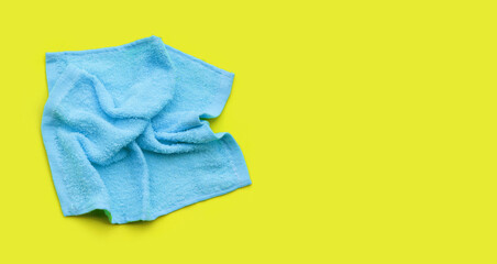 Blue towel for cleaning on green background.