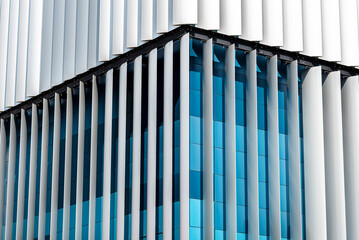 The facade of a modern building with an innovative facade made of automatic, movable blinds.