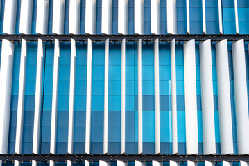 The facade of a modern building with an innovative facade made of automatic, movable blinds.