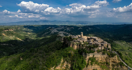 Fototapeta na wymiar Civita di Bagnoregio, Italy (‘The dying city’)- Aerial panoramic view of historic town of and surrounding hills and valleys of Lazio region.