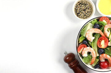 Mixed Vegetable Salad with Shrimp in a Bowl. Healthy green salad with shrimp and vegetables isolated on white background. Boiled shrimp. Healthy food. Seafood. Top view have copy space.