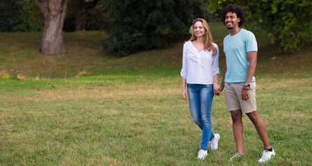 Young couple walking in the nature on a sunny summer day