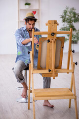 Young man enjoying painting at the studio