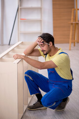 Fototapeta na wymiar Young male carpenter working at home