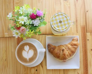 Breakfast whit croissant, cup of coffee and pineapple juice