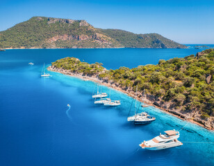 Aerial view of beautiful yachts and boats on the sea at sunset in summer. Gemiler Island in Turkey....