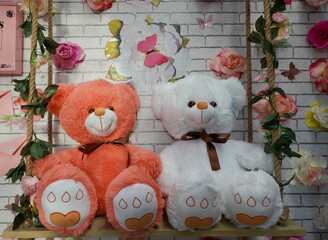 Plush toys pink and white teddy bears in shop 