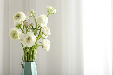 Vase with bouquet of beautiful ranunculus flowers on light background, closeup