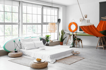 Stylish interior of bedroom with sup boards