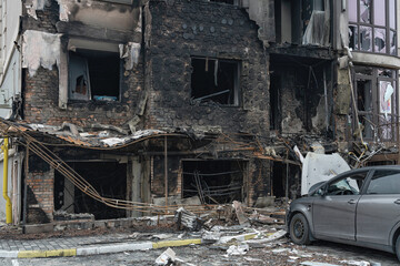 Buildings and car destroyed Buildings and car destroyed after hit military projectile. Ukraine. Bucha (war concept)a missile strike. Ukraine. (war concept)