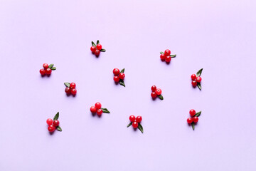 Red lingonberries with leaves on lilac background