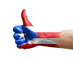 Hand making thumb up painted with flag of puerto rico