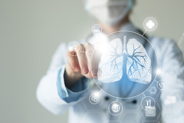 Unrecognizable female doctor holding graphic virtual visualization model of Lungs organ in hands. Multiple virtual medical icons.