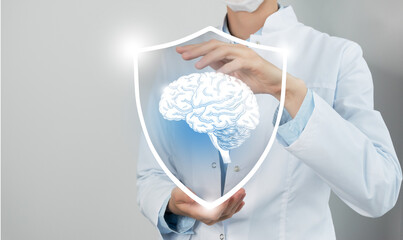 Unrecognizable female doctor holding shield and graphic virtual visualization of Brain organ in...