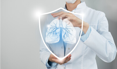 Unrecognizable female doctor holding shield and graphic virtual visualization of Lungs organ in...
