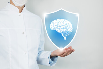 Unrecognizable female doctor holding shield and graphic virtual visualization of Brain organ in...