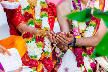 Fototapeta na wymiar Indian Hindu wedding ceremony and rituals bride and groom's hands close up