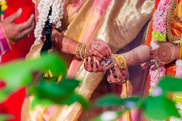 Indian Hindu wedding ceremony and rituals bride and groom's hands close up