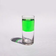 Half full glass on light background. Creative optimistic concept. Positive thinking idea.