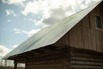 Old roof of building. House in village. Roof of house.