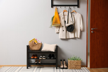 Hallway interior with stylish furniture, clothes and accessories