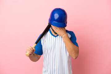 Baseball player with helmet and bat isolated on pink background with tired and sick expression
