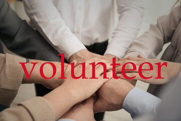Group of volunteers putting hands together, closeup