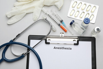 Flat lay composition of clipboard with word Anesthesia and drugs on light grey background