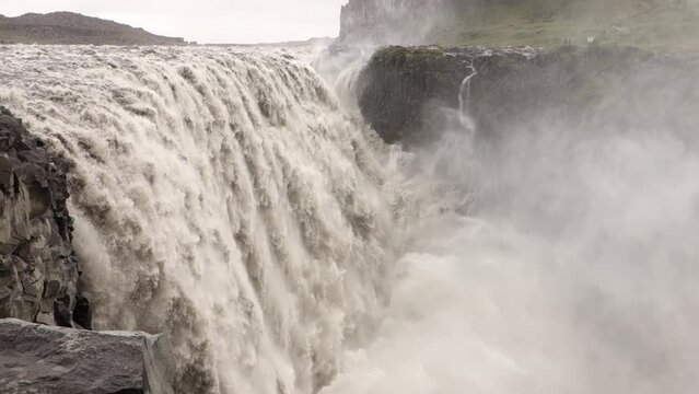 Lendscape with Dettifoss waterfall in Iceland after heavy floods with muddy water