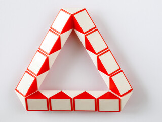 red and white bicolor magic snake Transformable twist puzzle in shape of triangle isolated on white...
