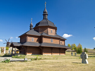 ukrainian traditional wooden church and ancient stone cross. traditional Ukrainian history