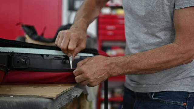 Car Seat Upholstery Repair in Workshop, Workers Hands Using Knife