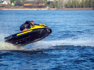 Guy is rolling on a water scooter at high speed.