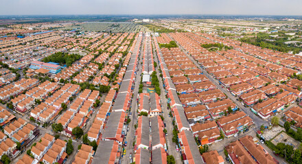 Aerial drone shot of suburb area surrounded by high density village in overpopulation city for...