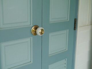 Close-up of antique door lock on an antique blue wooden door