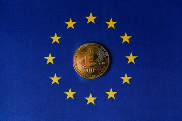Gold bitcoin coin in the center of the EU flag, top view