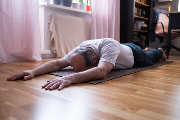 Senior sporty man lying in Dead Body exercise or Corpse pose, Savasana pose