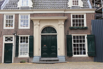 Amsterdam Historic Oude Kerk Church Annex Building Facade with Green Wooden Doors and Shutters, Netherlands
