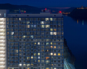 Siberian city of Krasnoyarsk. Night view from above on the Yenisei River. High-rise new residential building