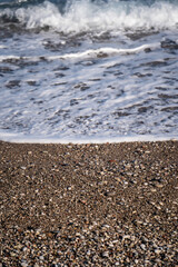 Fototapeta na wymiar Rocky beach top view with a sea ​​wave.