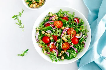 Zelfklevend Fotobehang Vegetarian chickpea salad with tomatoes, arugula, parsley, spinach and red onion. Healthy food, diet. Top view © Sea Wave