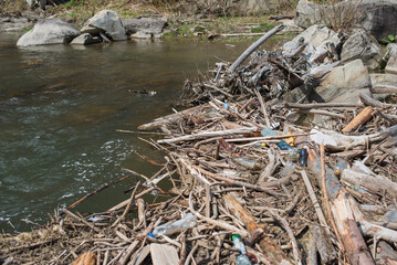 Polluted nature. Water with plastic bottles.
