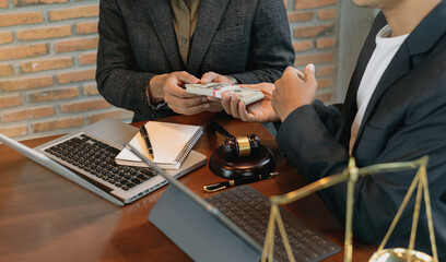 justice and law concept.passing bribe money in the envelop at lawyer office room..