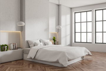 Fototapeta na wymiar Corner view on bright bedroom interior with empty white wall