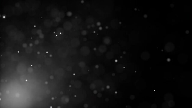 Abstract loop dust particles glow floating on black background with flare light on bottom left for your screen project overlay. 4K 3D seamless looping white particles dust fly in the air. Looped anima