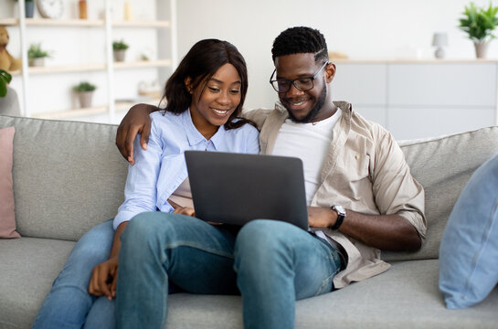 Portrait of African American couple using laptop at home