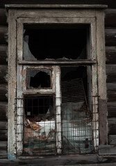 Broken window in an abandoned house in Russia