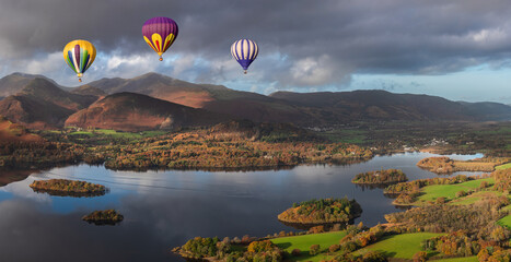 Digital composite image of hot air balloons over Beautiful landscape Autumn image of view from Walla Crag in Lake District, over Derwentwater looking towards Catbells and distant mountains - Powered by Adobe